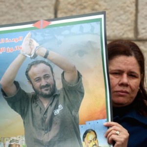 Palestinian women hold portraits of Palestinian prisoner Marwan Barghouti during a rally in solidarity with Palestinian prisoners in Israeli jails outside the Red Cross building in the West Bank city of Ramallah. March 27, 2012. Photo by Issam Rimawi/Flash90