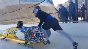 Dave Nicholls, seated, rides in the bobsled. (Courtesy of Nicholls)